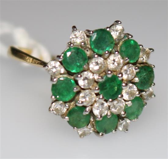 An 18ct gold, emerald and diamond cluster ring, size M.